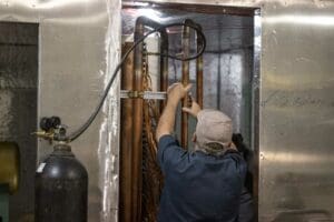 Bry-Air USA service technician working on a commercial dehumidifier